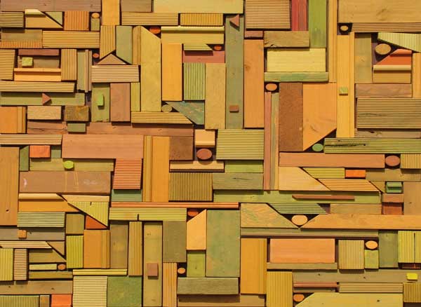 bas-relief made from recycled colour stained timbers in a geometric jigsaw pattern